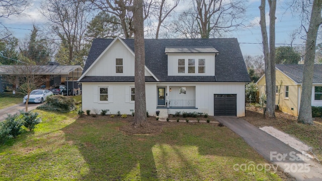 view of front of home featuring a porch, a garage, a shingled roof, driveway, and a front lawn