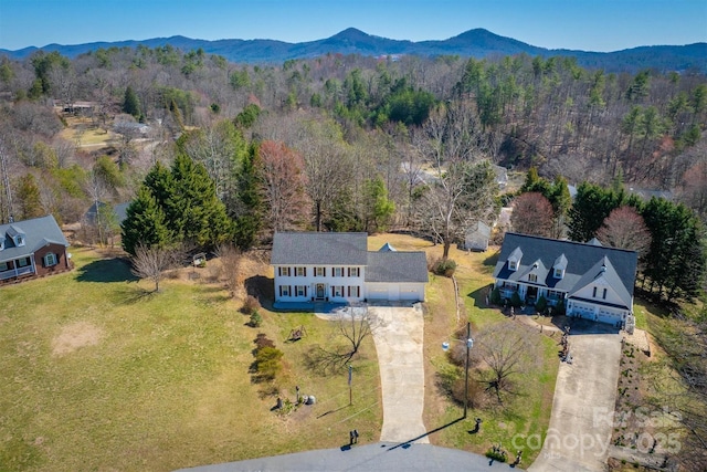 drone / aerial view with a forest view and a mountain view