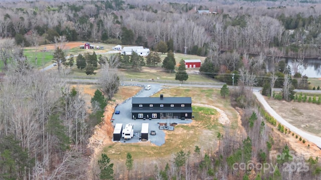 drone / aerial view with a wooded view