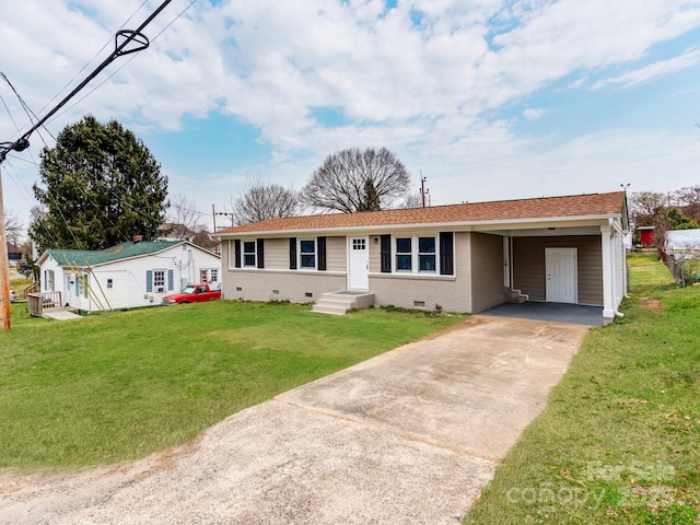 ranch-style house with an attached carport, brick siding, concrete driveway, crawl space, and a front lawn