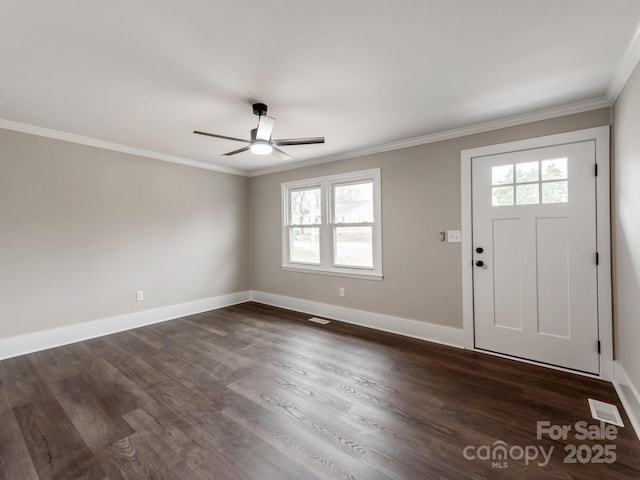 entrance foyer featuring dark wood-style floors, visible vents, baseboards, and crown molding