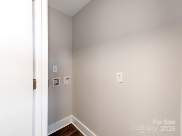 laundry area with laundry area, washer hookup, dark wood finished floors, and baseboards