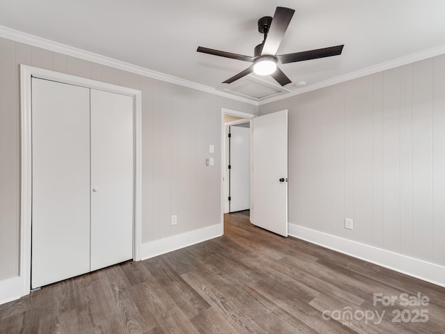 unfurnished bedroom with ornamental molding, ceiling fan, baseboards, and wood finished floors