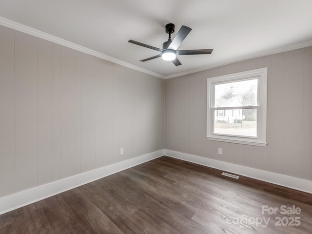 unfurnished room with dark wood-style floors, crown molding, visible vents, ceiling fan, and baseboards