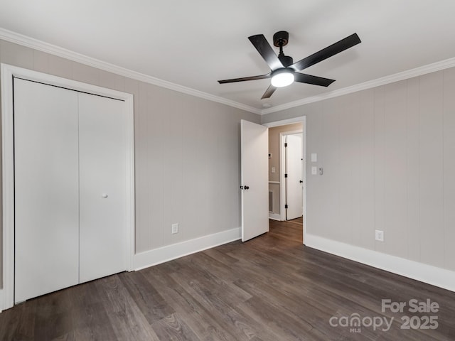 unfurnished bedroom with a ceiling fan, crown molding, baseboards, and wood finished floors