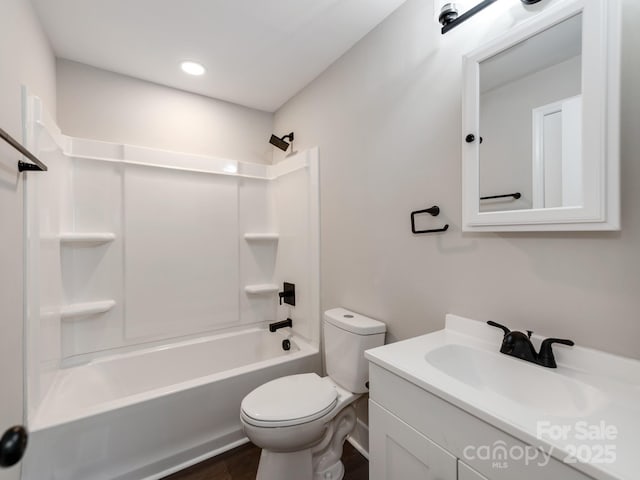 full bathroom featuring shower / bathing tub combination, vanity, and toilet