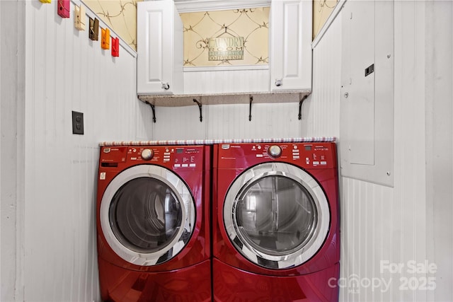 laundry area with cabinet space, electric panel, and washer and clothes dryer