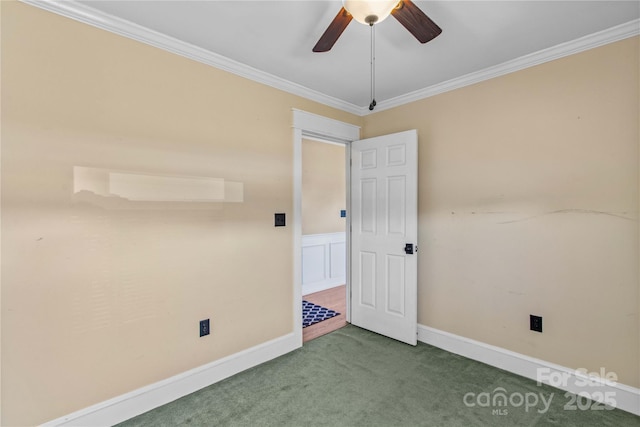 carpeted empty room with ornamental molding, ceiling fan, and baseboards