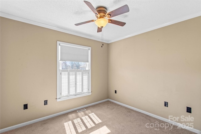 empty room featuring a textured ceiling, visible vents, and carpet flooring