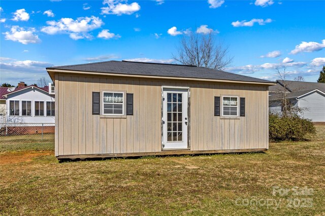 view of outdoor structure with an outbuilding and fence