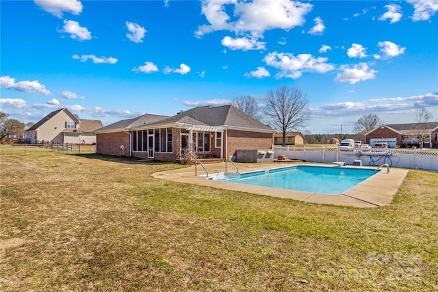 view of swimming pool featuring a fenced in pool, a sunroom, a fenced backyard, and a yard