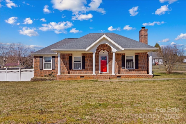 view of front of home with brick siding, a chimney, a front yard, crawl space, and fence