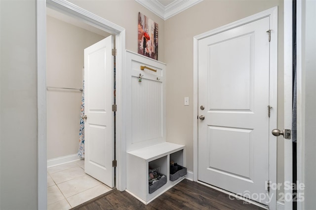 mudroom featuring crown molding, baseboards, and wood finished floors