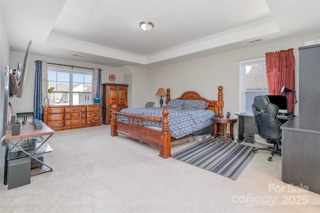 bedroom featuring a raised ceiling, visible vents, carpet flooring, and multiple windows