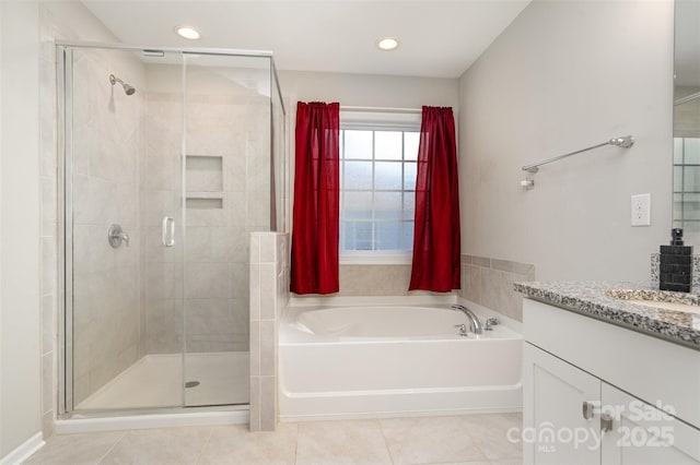 bathroom featuring a garden tub, a shower stall, tile patterned flooring, and vanity