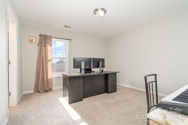 home office featuring light carpet, visible vents, and baseboards