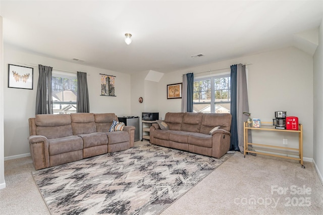 living area with baseboards, visible vents, and carpet flooring