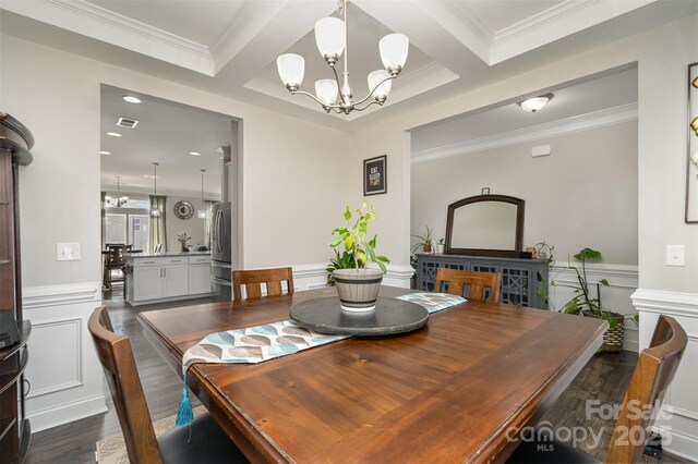 dining room featuring an inviting chandelier, dark wood-style floors, and crown molding