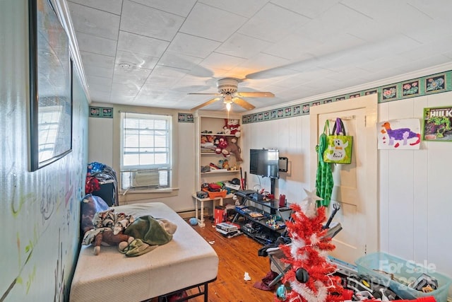 bedroom featuring wood-type flooring, ceiling fan, and baseboard heating