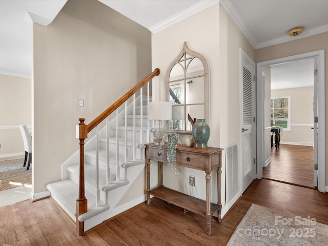 staircase with hardwood / wood-style floors and crown molding