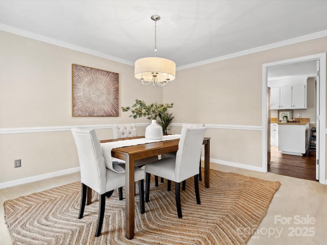 carpeted dining space with ornamental molding and a chandelier