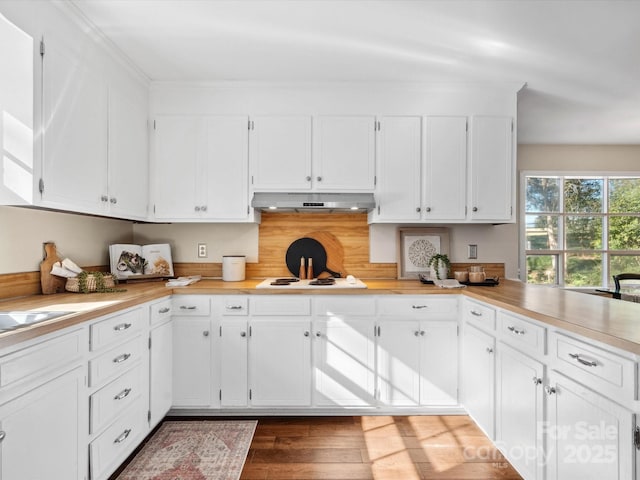 kitchen featuring white cabinets, dark hardwood / wood-style floors, and white cooktop