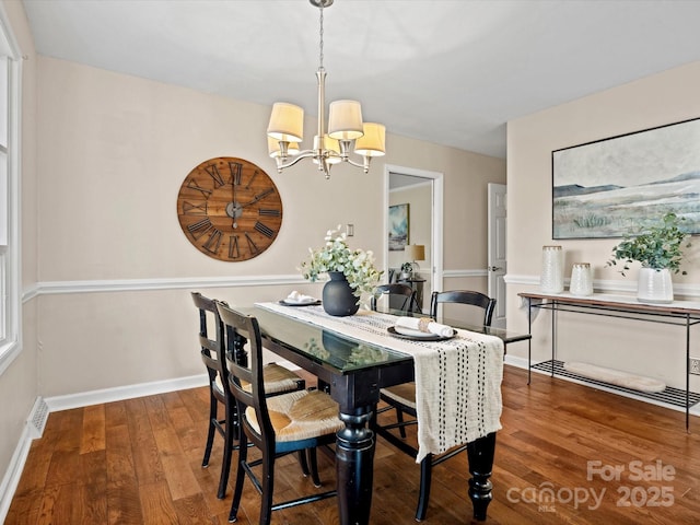 dining space with a notable chandelier and wood-type flooring