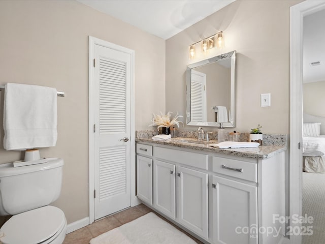 bathroom featuring toilet, tile patterned flooring, and vanity