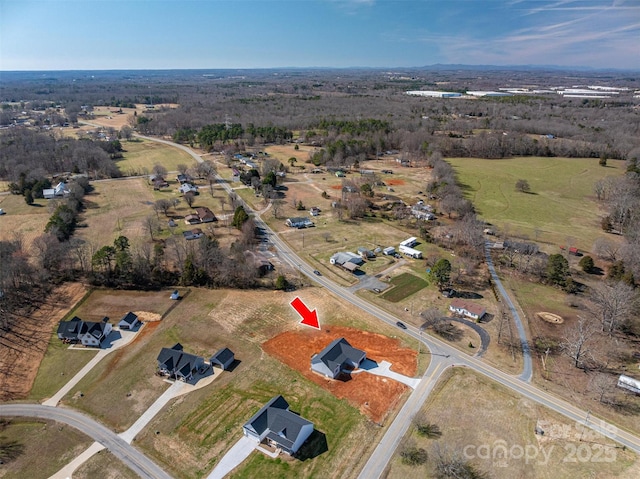 birds eye view of property featuring a rural view