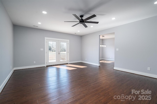 empty room featuring ceiling fan, french doors, and dark hardwood / wood-style flooring