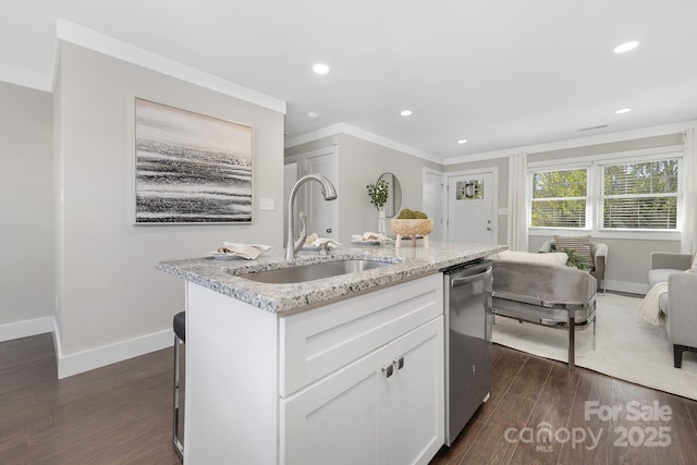 kitchen featuring dark wood-style flooring, white cabinets, a sink, dishwasher, and baseboards