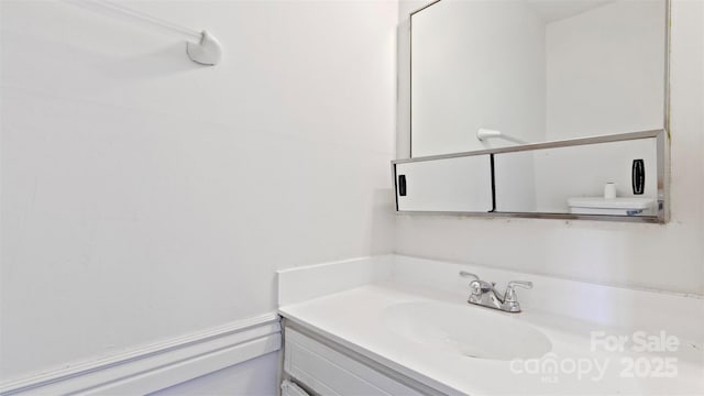 bathroom featuring toilet and vanity