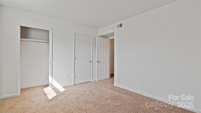 unfurnished bedroom with light colored carpet