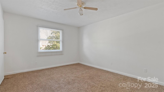 spare room featuring carpet flooring, ceiling fan, and a textured ceiling