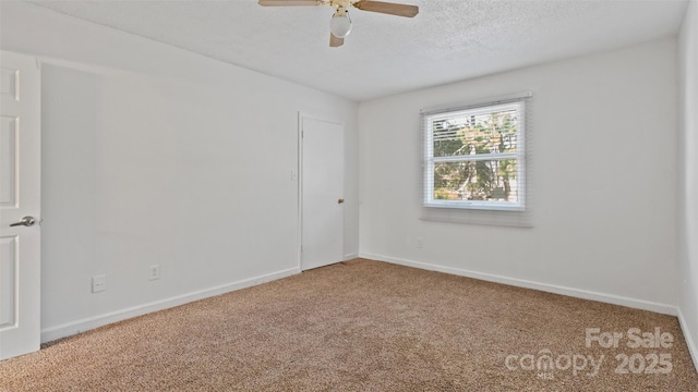 spare room featuring a textured ceiling, ceiling fan, and carpet floors