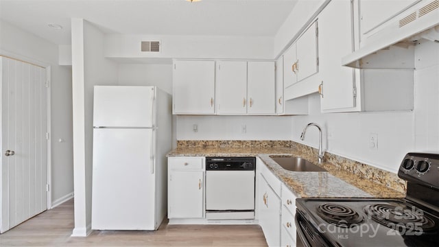 kitchen with white cabinetry, sink, white appliances, and light stone countertops