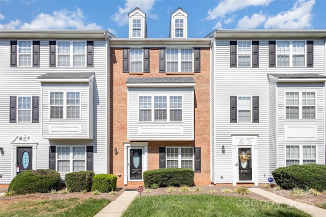 townhome / multi-family property featuring brick siding