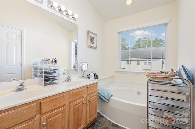 full bathroom featuring a bath, double vanity, and a sink