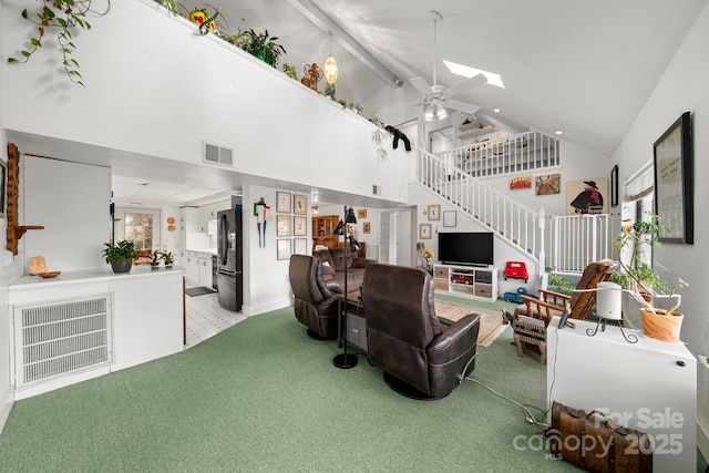 53 Hackberry Ln, Waynesville, NC 28785 - living room featuring stairs, high vaulted ceiling, carpet, a ceiling fan, and a skylight