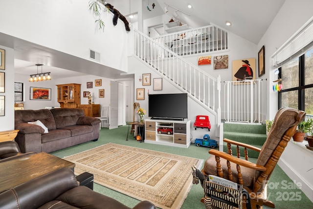 53 Hackberry Ln, Waynesville, NC 28785 - living room with high vaulted ceiling, carpet floors, and stairs