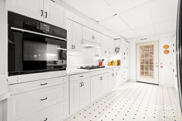 53 Hackberry Ln, Waynesville, NC 28785 - kitchen featuring black oven, gas cooktop, white cabinets, light countertops, and a drop ceiling