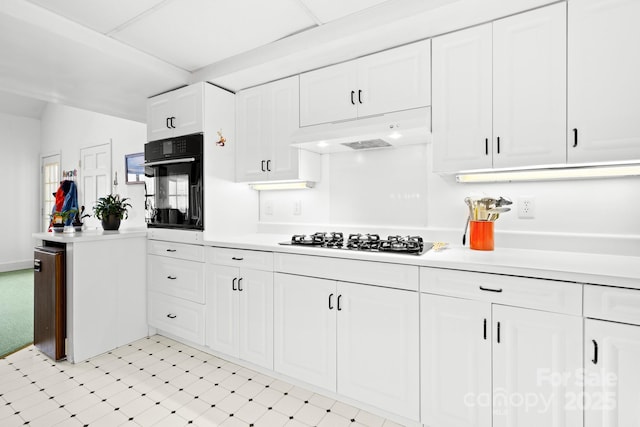 53 Hackberry Ln, Waynesville, NC 28785 - kitchen with gas cooktop, oven, under cabinet range hood, light countertops, and white cabinetry