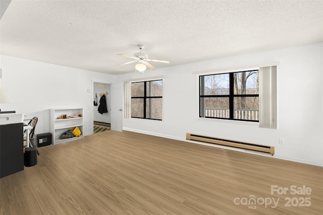 53 Hackberry Ln, Waynesville, NC 28785 - unfurnished office featuring a baseboard heating unit, a textured ceiling, wood finished floors, and ceiling fan