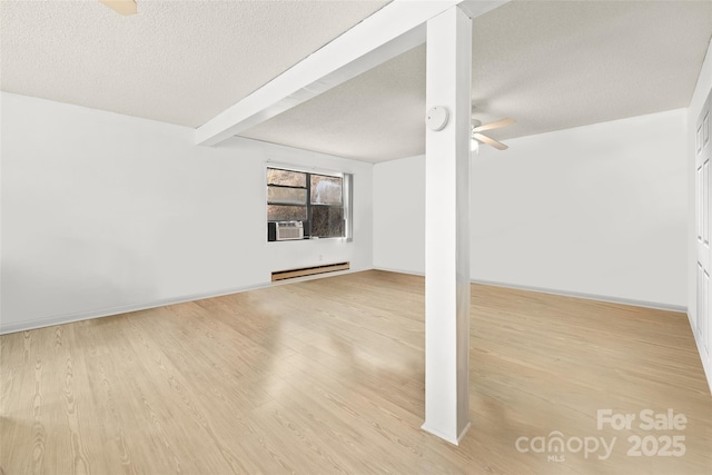 53 Hackberry Ln, Waynesville, NC 28785 - unfurnished living room featuring baseboard heating, a ceiling fan, a textured ceiling, wood finished floors, and beam ceiling