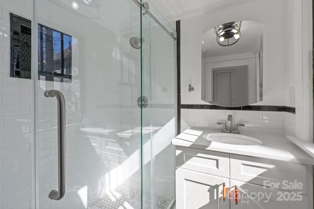 bathroom with vanity, walk in shower, and crown molding