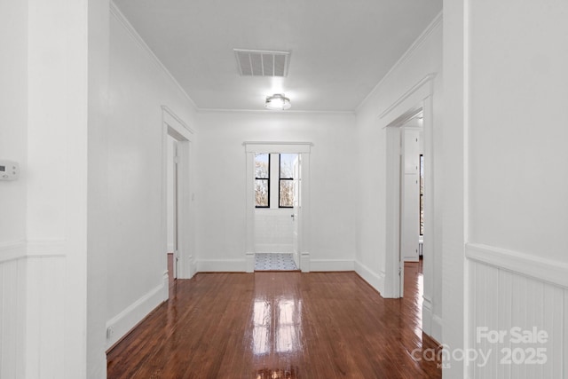 interior space with dark hardwood / wood-style flooring and ornamental molding