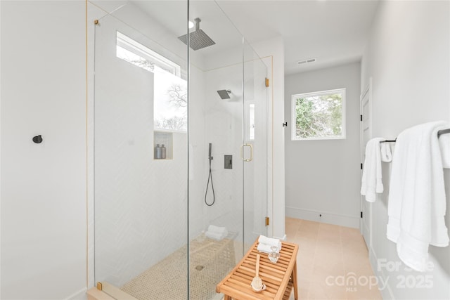 bathroom featuring a stall shower, visible vents, and baseboards