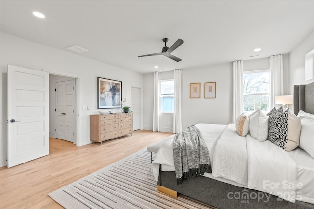 bedroom with a ceiling fan, light wood-type flooring, baseboards, and recessed lighting