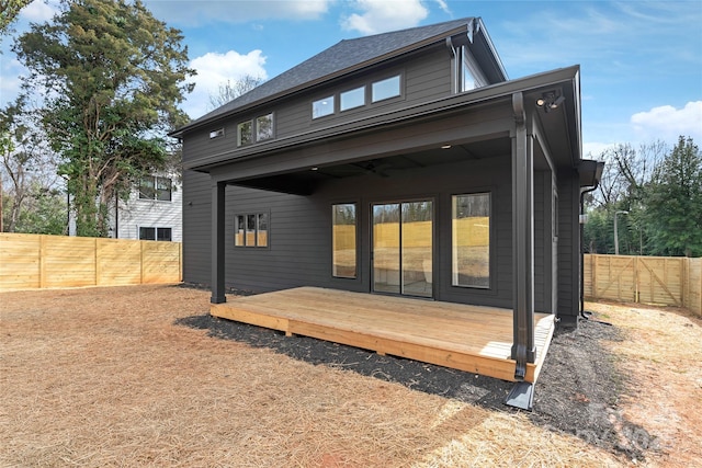 back of property featuring a fenced backyard and a deck