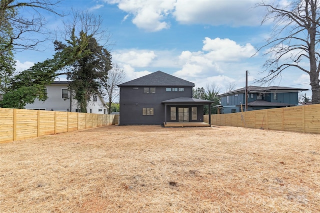 back of house featuring a fenced backyard